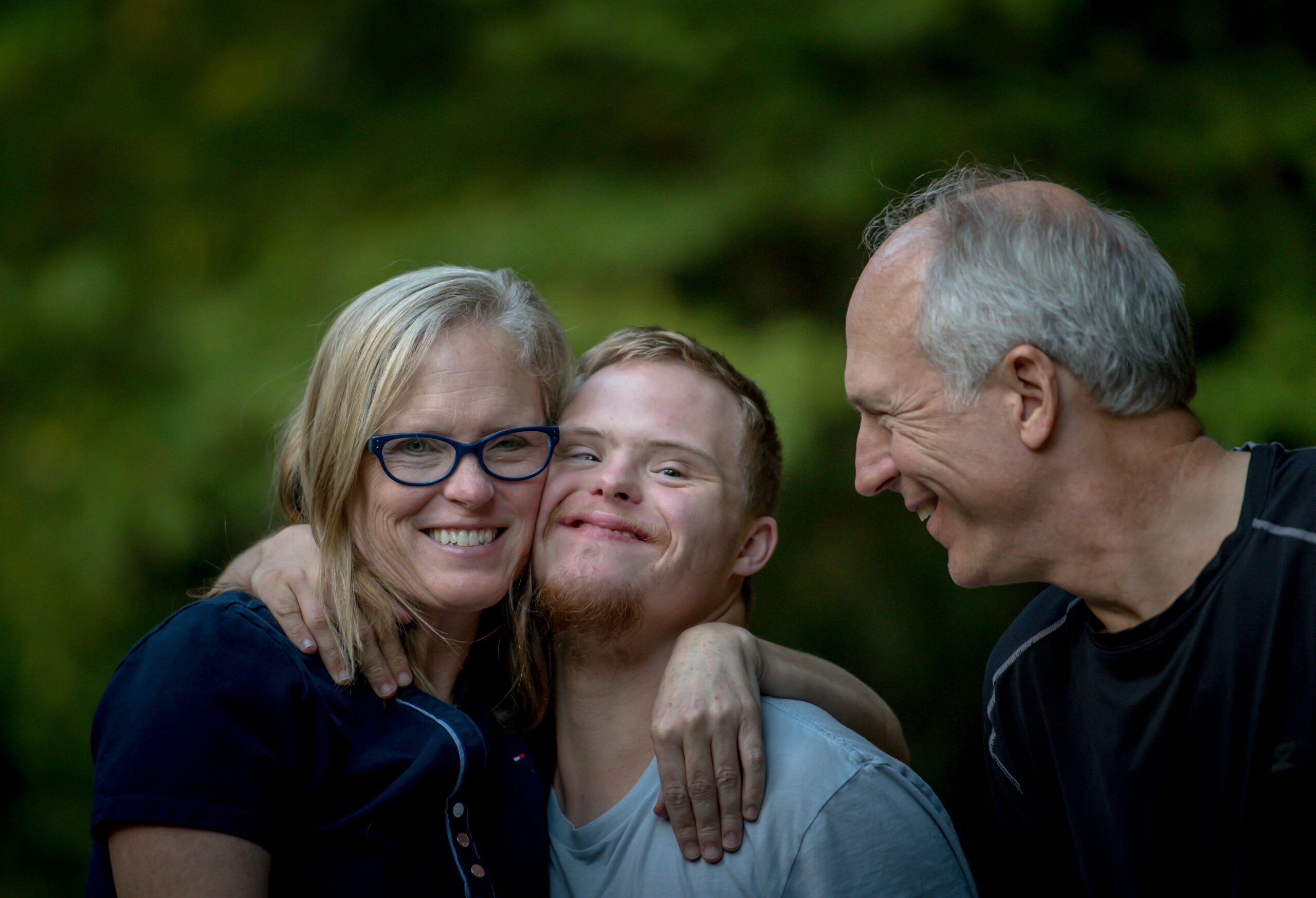 family smiling and hugging after changing NDIS providers