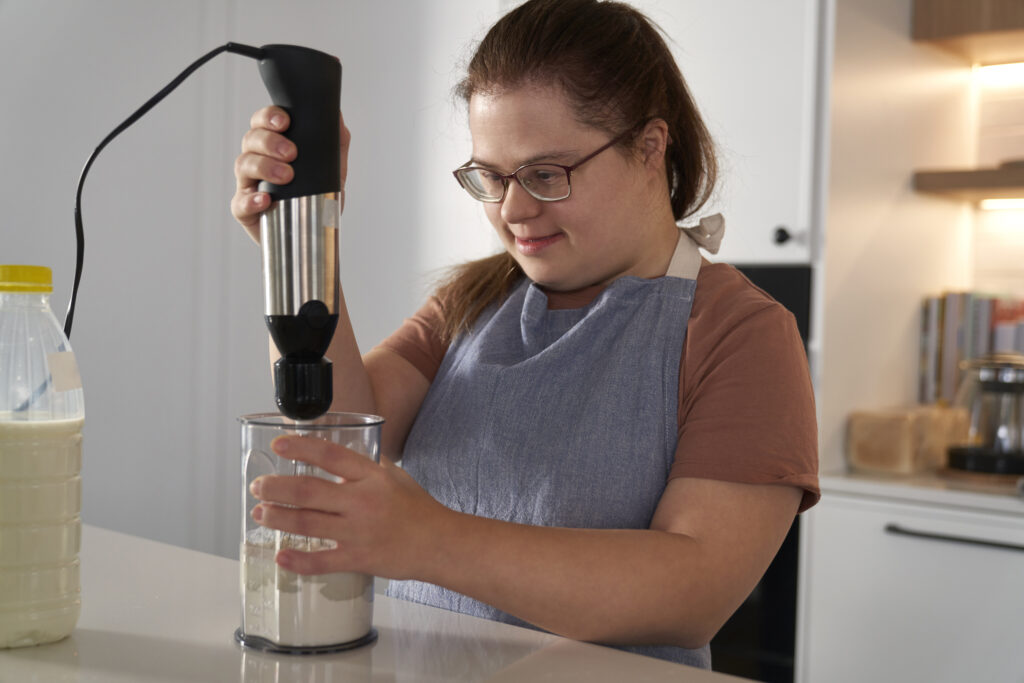 Independent Down syndrome woman baking in domestic kitchen